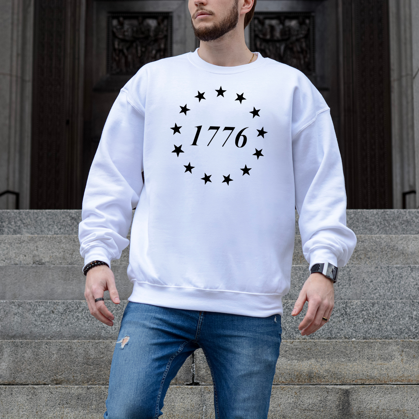 1776 circle of stars graphic on white unisex crewneck sweatshirt, modeled on courthouse steps.
