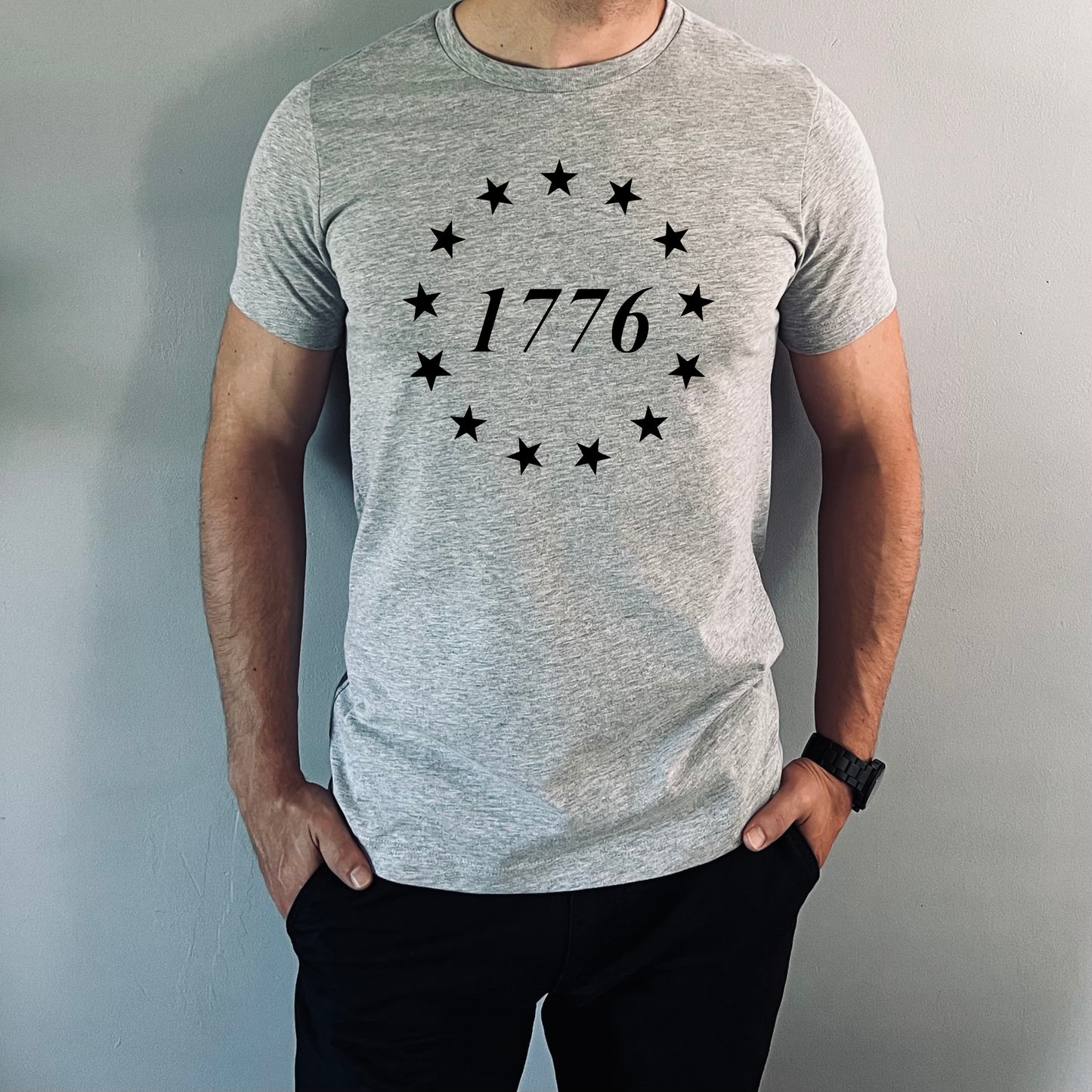 Athletic gray 1776 t-shirt with 13 black stars in a circle and the year 1776 in the center.