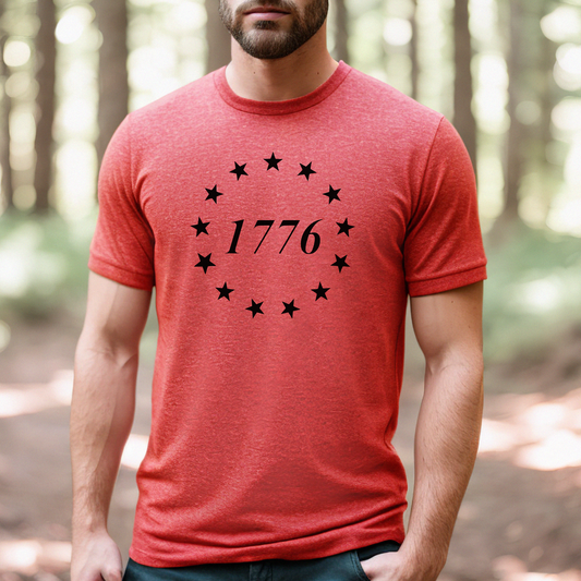 Heather red t-shirt with black 1776 circular star design, worn outdoors in the woods.