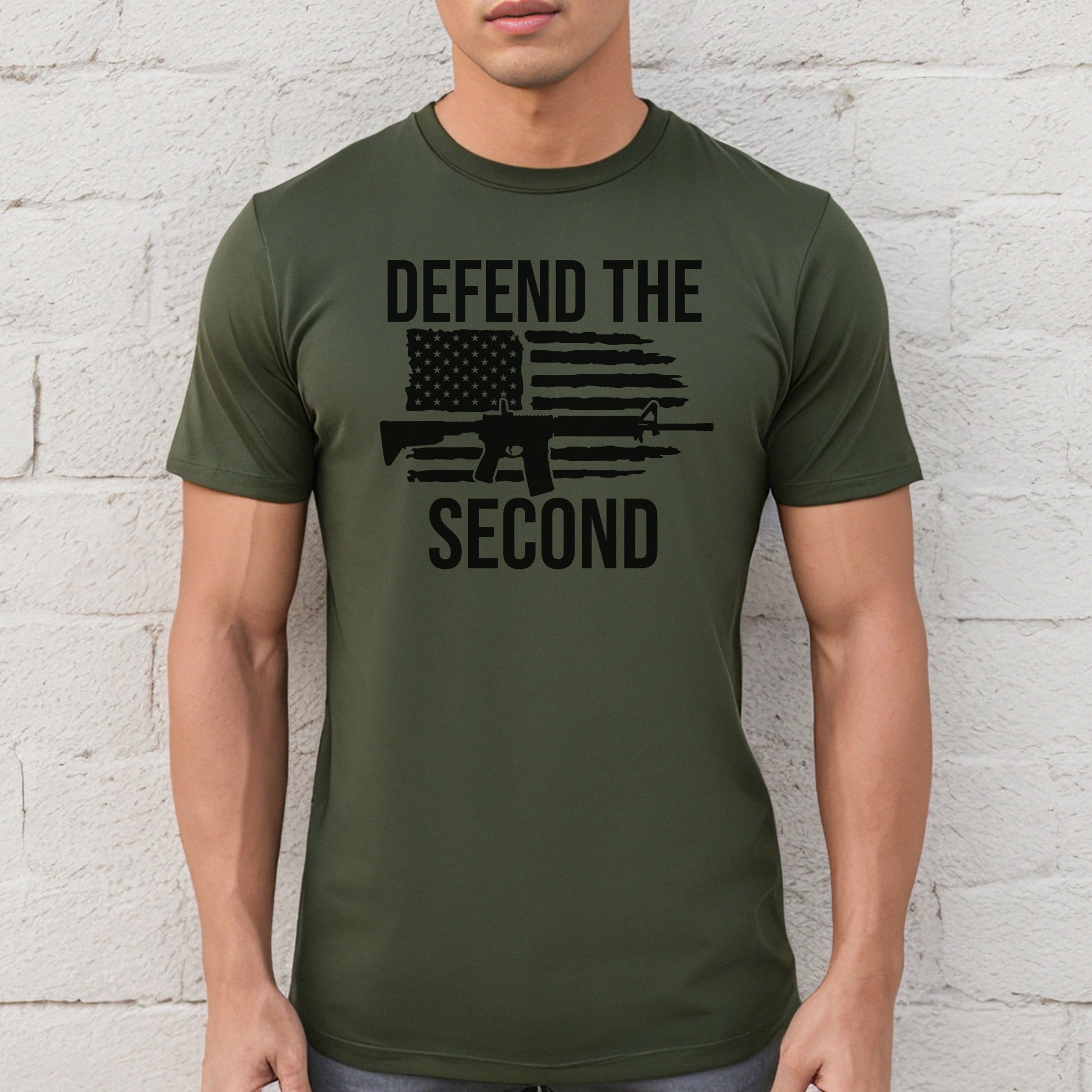 Man wearing a military green "Defend the Second" t-shirt with rifle and American flag graphic.