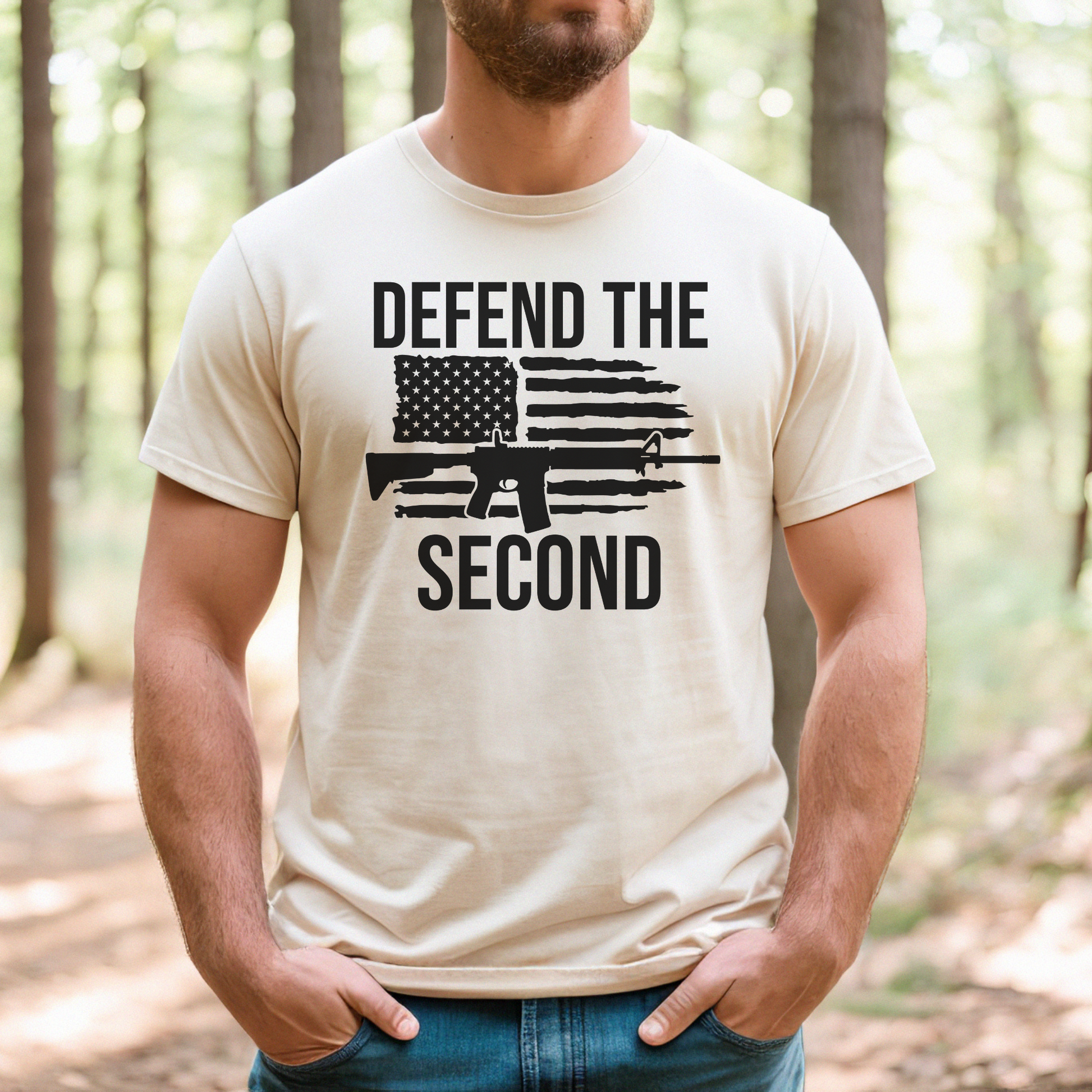 Man outdoors wearing a natural-colored "Defend the Second" t-shirt featuring black rifle and distressed flag design.