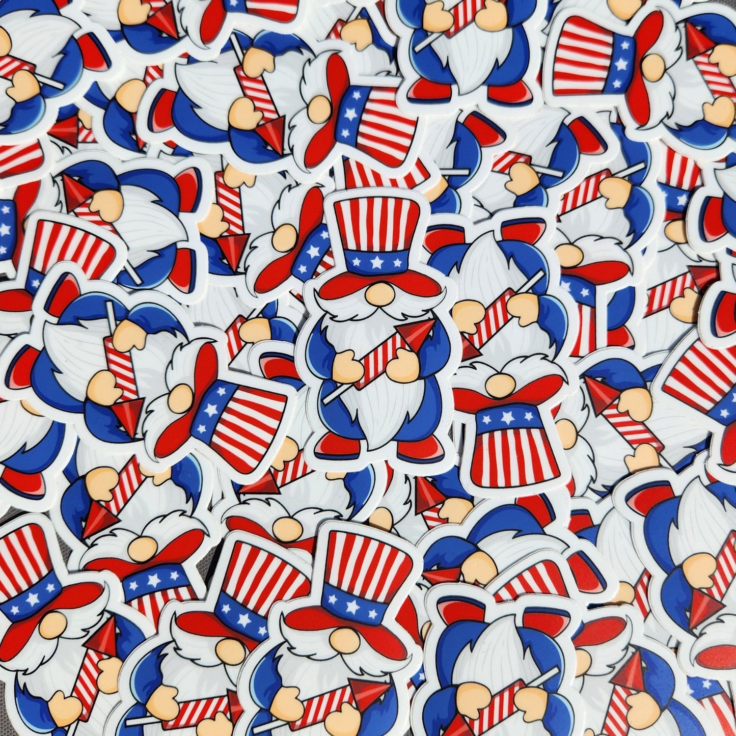 Pile of patriotic gnome stickers featuring stars and stripes top hats and red firework rockets.