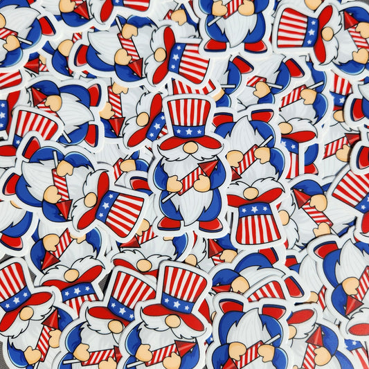 Pile of patriotic gnome stickers featuring stars and stripes top hats and red firework rockets.