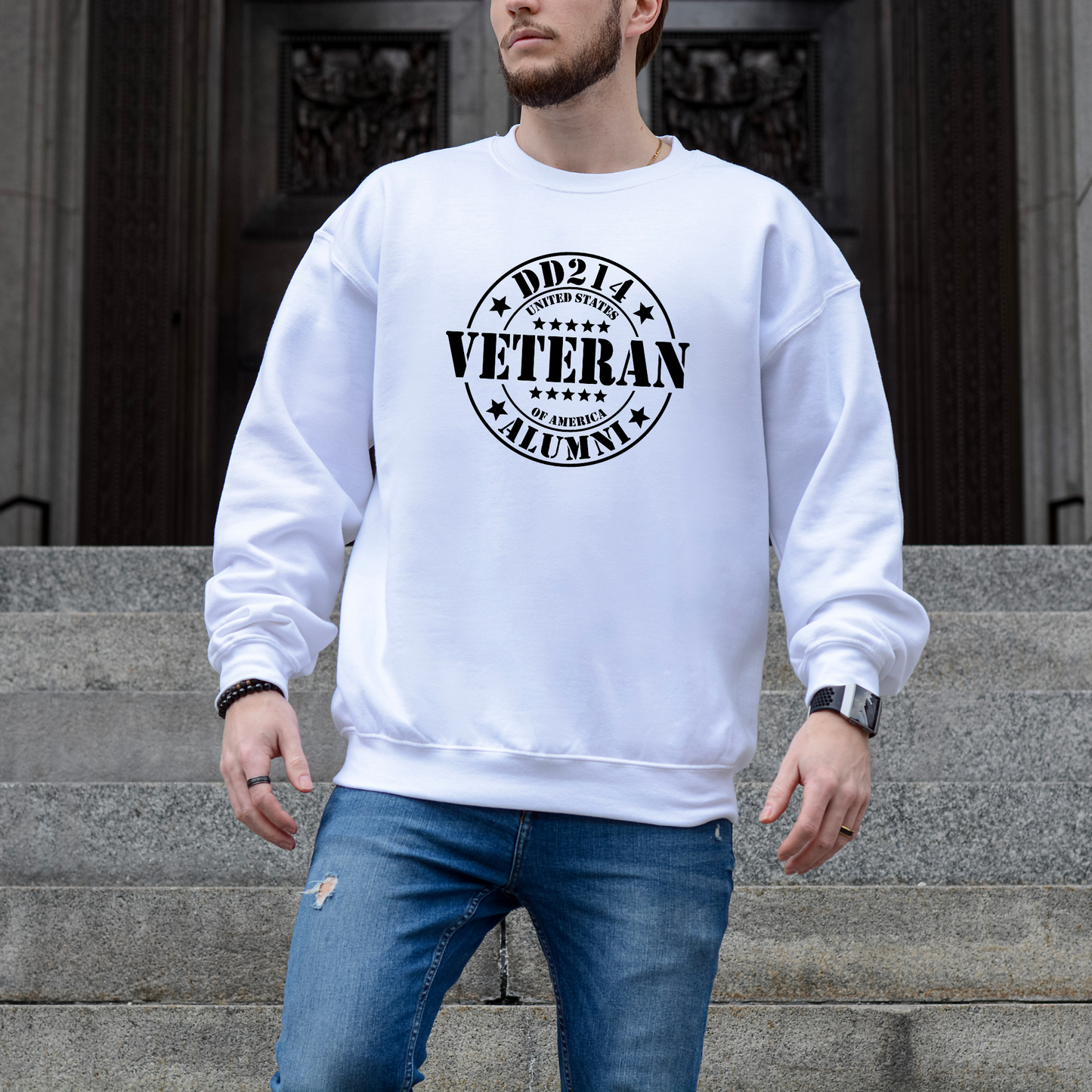 DD214 Veteran Alumni stamp graphic on white crewneck sweatshirt, modeled on stone courthouse steps.
