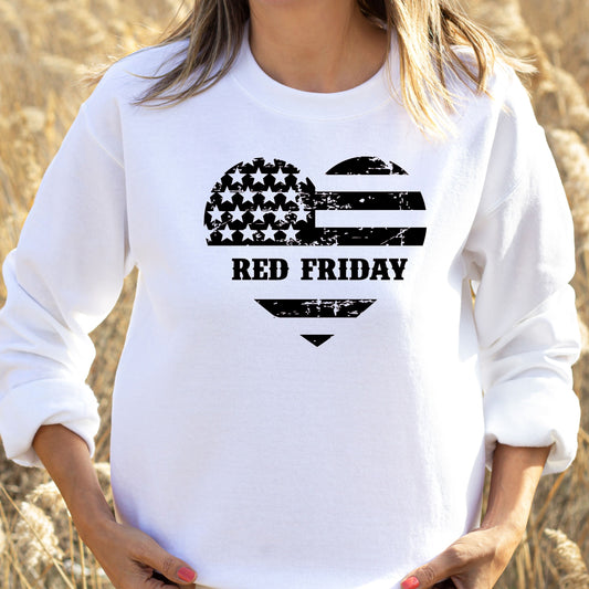 Red Friday heart-shaped American flag graphic on white women's crewneck sweatshirt, modeled in golden field.