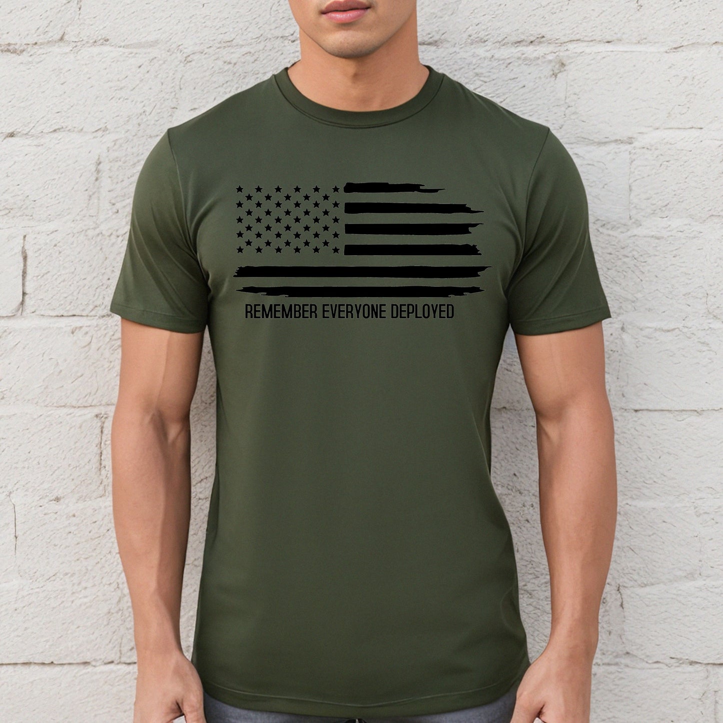 Black flag and Remember Everyone Deployed on military green performance t-shirt, modeled against white wall.