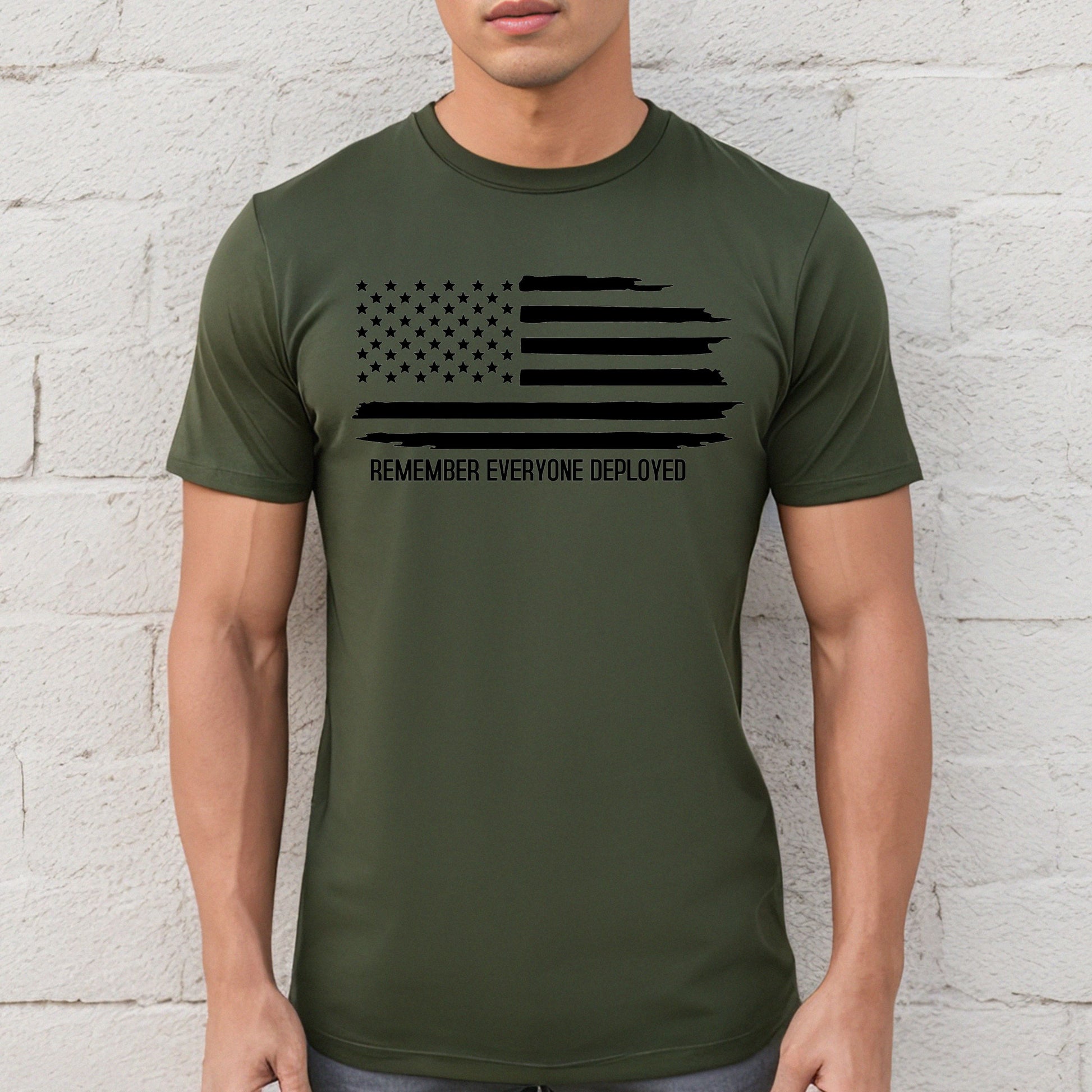 Black flag and Remember Everyone Deployed on military green performance t-shirt, modeled against white wall.
