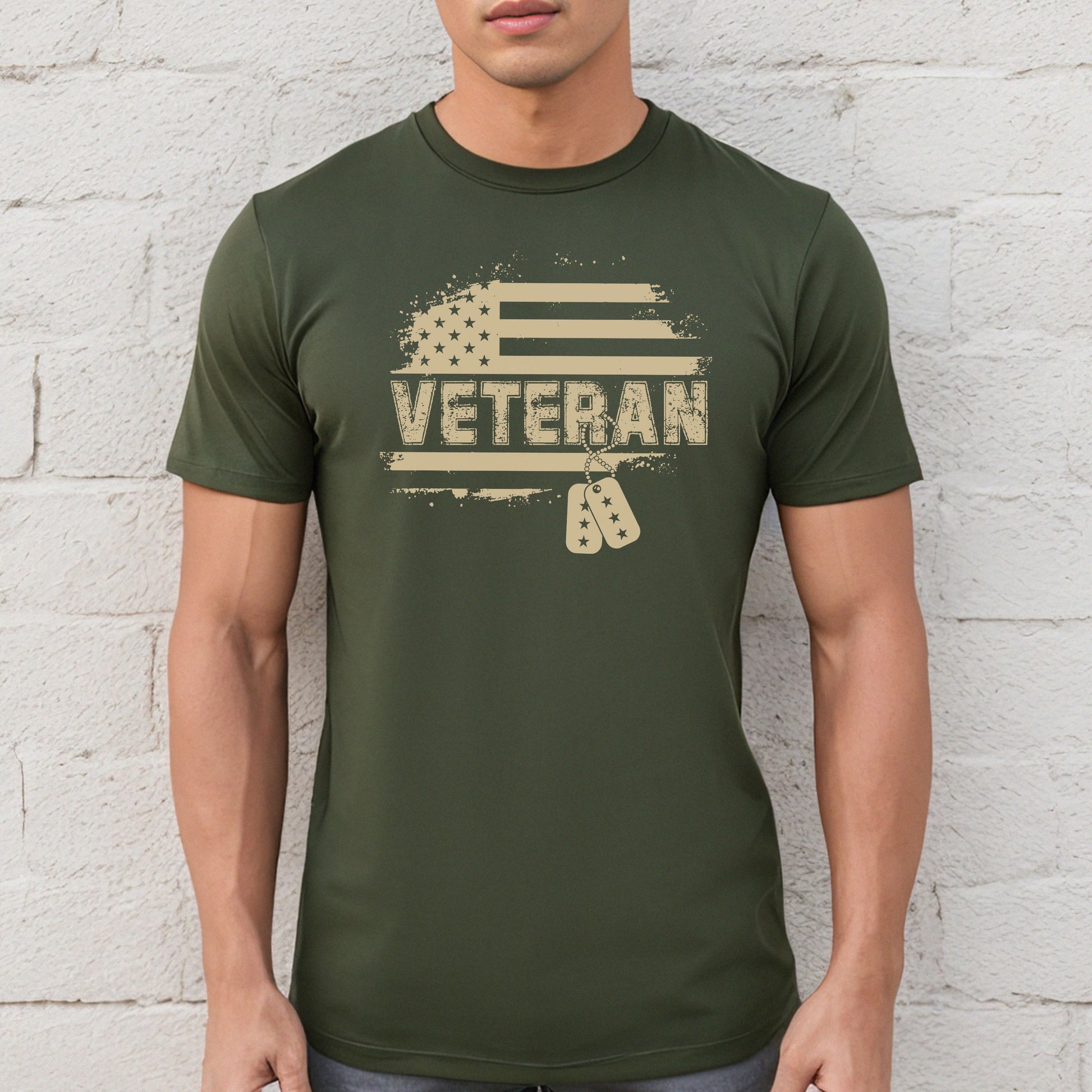 Flag and Veteran text with dog tags on military green performance t-shirt, modeled against white wall.