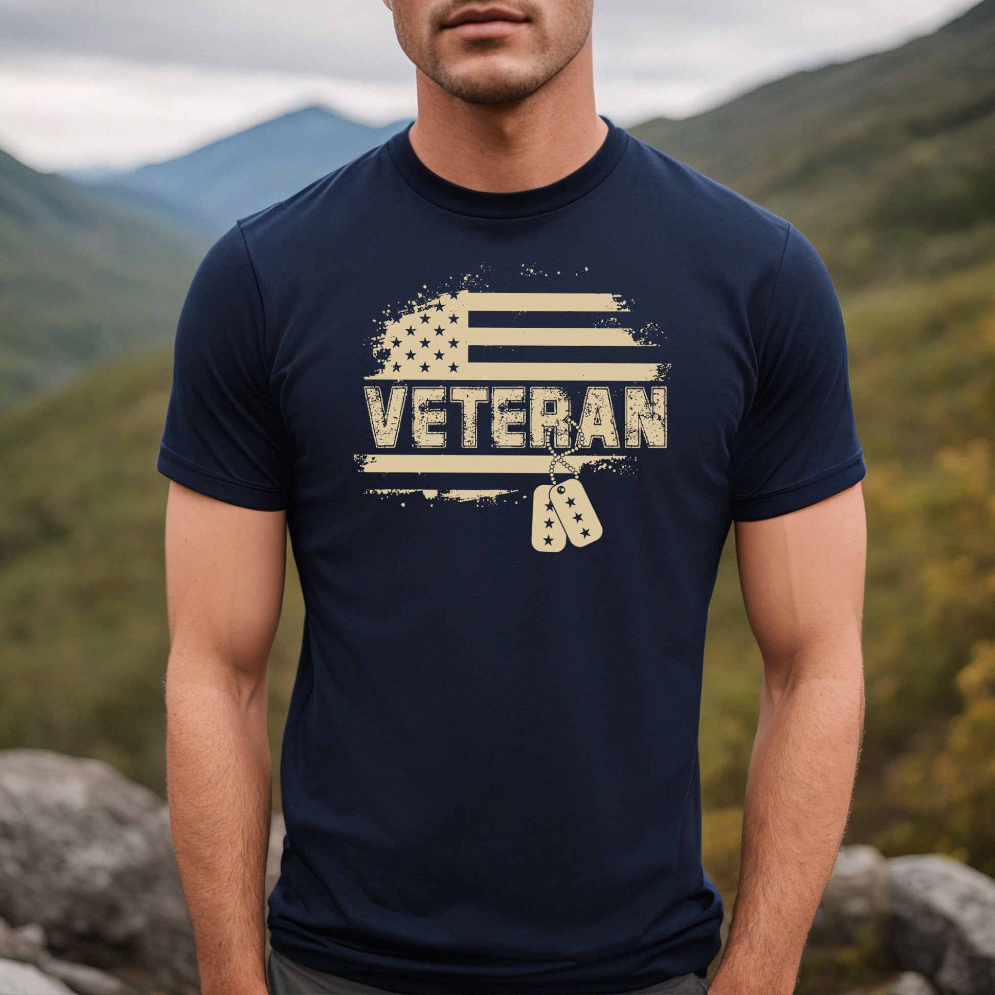 Grunge Veteran flag and tag graphic on navy men's t-shirt, modeled outdoors in the mountains.