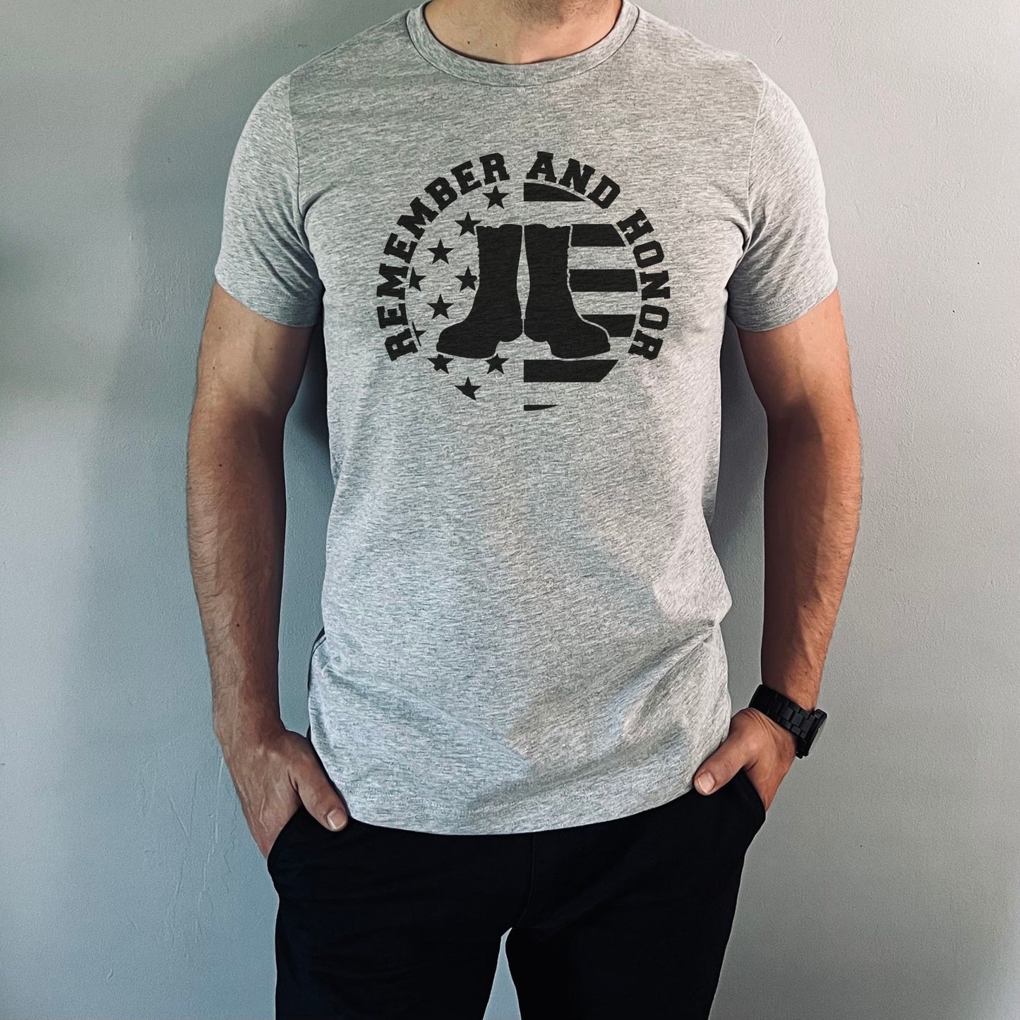 Men's athletic gray 'Remember and Honor' shirt with black military boots and vintage American flag circle graphic.